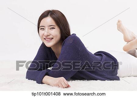 Stock Photo - close up shot of a woman lying on a carpet. Fotosearch