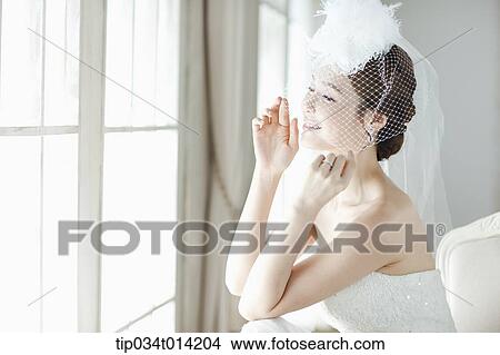 Picture - close up shot of a woman wearing wedding veils. Fotosearch