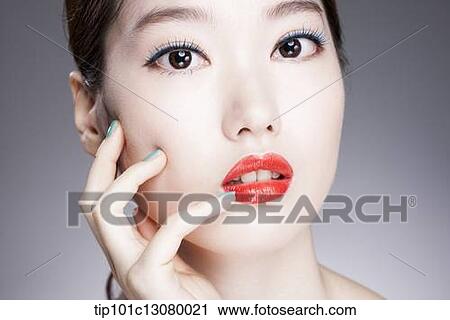 Stock Image - close up shot of a woman with red lipstick. Fotosearch