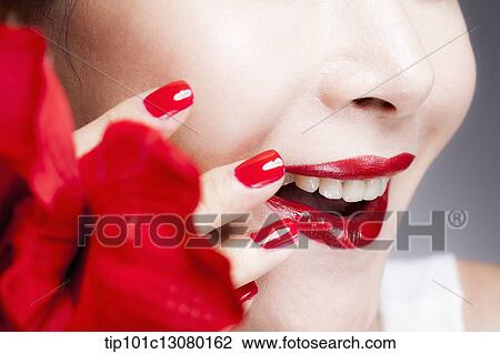 close up shot of a woman's red nails on a face with red lips View Large Photo Image Stock Image - close up shot of a woman's red nails on a face with red lips. Fotosearch