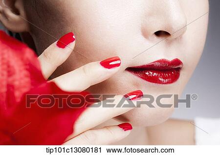 close up shot of a woman's red nails on a face with red lips View Large Photo Image Stock Image - close up shot of a woman's red nails on a face with red lips. Fotosearch