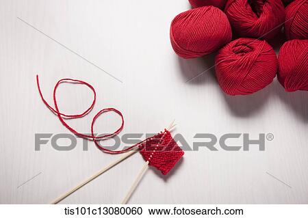 Stock Image - close up shot of red knit stitches. Fotosearch