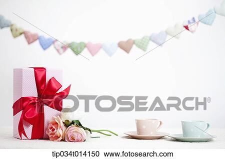 different colors of heart shapes along each other above flower and gifts View Large Photo Image Stock Image - different colors of heart shapes along each other above flower and gifts. Fotosearch
