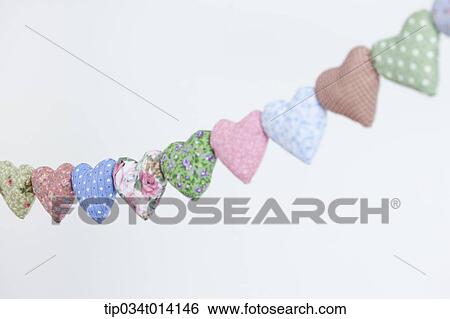 Stock Photograph - different colors of heart shapes along each other . Fotosearch