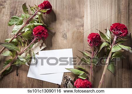 envelops and red flowers on wooden surface View Large Photo Image Stock Photograph - envelops and red flowers on wooden surface. Fotosearch