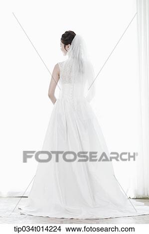 Picture - full shot of a woman in wedding dress. Fotosearch