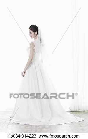 Stock Image - full shot of a woman in wedding dress. Fotosearch