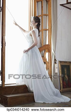 full shot of a woman in wedding dress stepping up the stairs View Large Photo Image Stock Image - full shot of a woman in wedding dress stepping up the stairs. Fotosearch