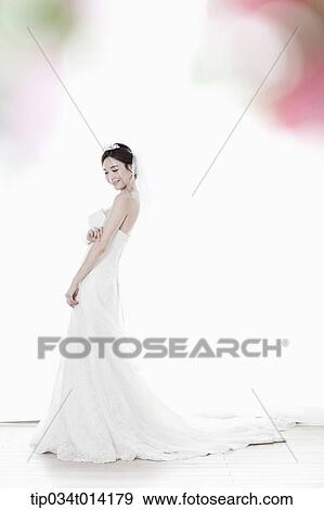 Stock Photo - full shot of a woman in wedding dress. Fotosearch