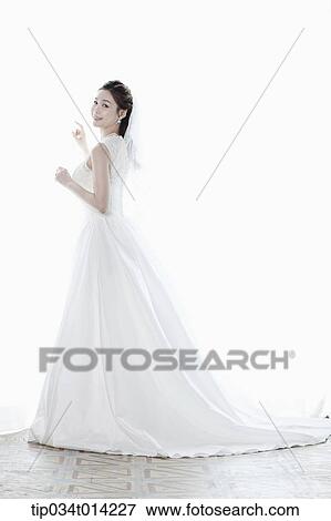 Stock Photo - full shot of a woman in wedding dress. Fotosearch