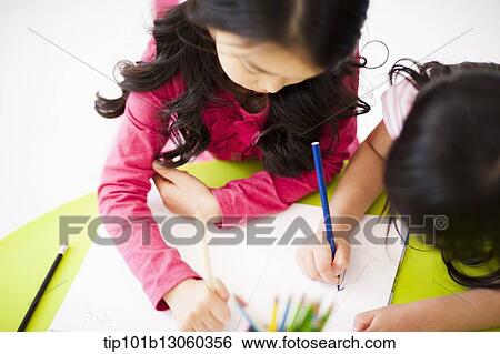 Stock Photograph - girls drawing on a sketchbook. Fotosearch
