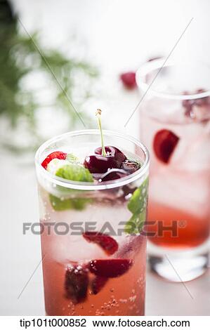 Stock Image - glasses of cherry juice with ice cubes. Fotosearch