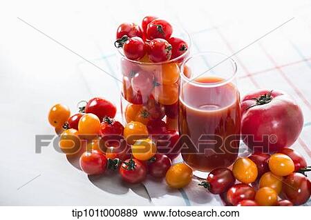 Stock Photo - glasses of tomato juice and tomatoes surrounding. Fotosearch