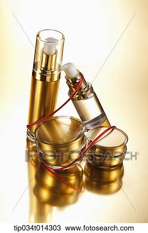 Stock Image - golden make up set in gold background. Fotosearch