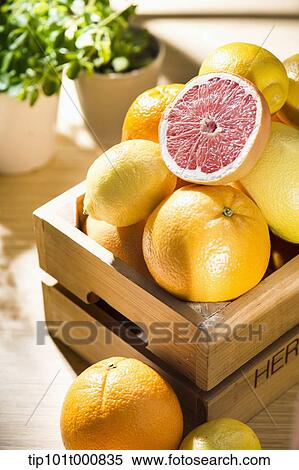 grape fruits in a box next to vases of plants View Large Photo Image Stock Photography - grape fruits in a box next to vases of plants. Fotosearch