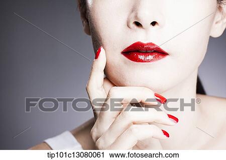 hand with red nail polish on woman's face with red lipstick View Large Photo Image Stock Image - hand with red nail polish on woman's face with red lipstick . Fotosearch