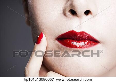 hand with red nail polish on woman's face with red lipstick View Large Photo Image Stock Photo - hand with red nail polish on woman's face with red lipstick . Fotosearch