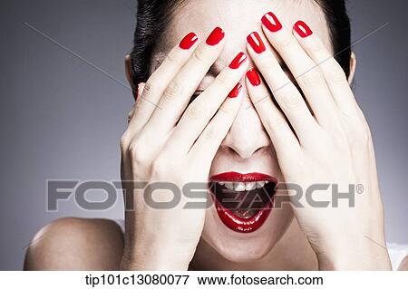 hands with red nail polish cover woman's eyes View Large Photo Image Stock Photo - hands with red nail polish cover woman's eyes. Fotosearch