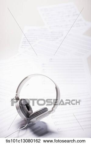 Stock Image - headset on musical papers . Fotosearch