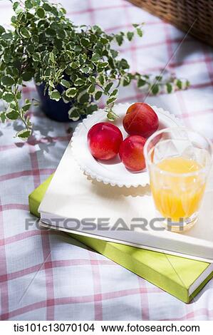 juice and a fruits on a pile of books View Large Photo Image Picture - juice and a fruits on a pile of books. Fotosearch