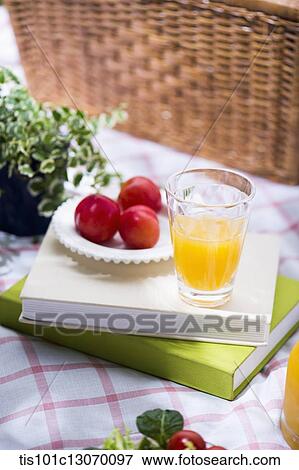 juice and a fruits on a pile of books View Large Photo Image Stock Photo - juice and a fruits on a pile of books. Fotosearch