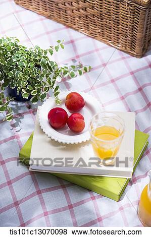 juice and a fruits on a pile of books View Large Photo Image Stock Photo - juice and a fruits on a pile of books. Fotosearch