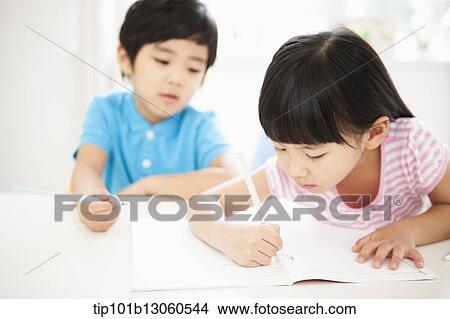 Picture - kids at desk learning together. Fotosearch
