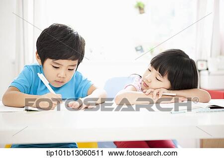 Stock Image - kids at desk learning together. Fotosearch