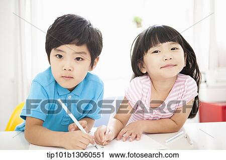 Stock Image - kids at desk learning together. Fotosearch