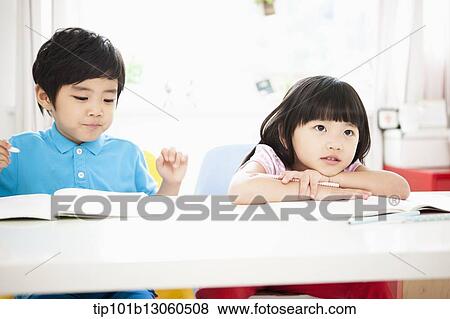 Stock Photo - kids at desk learning together. Fotosearch
