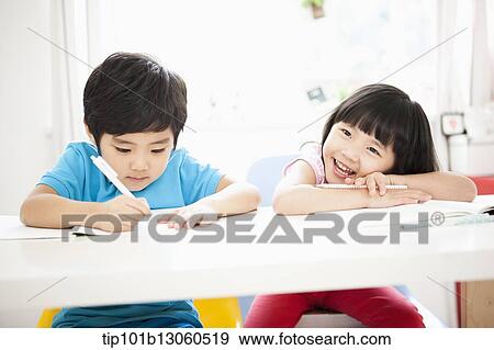 Stock Photo - kids at desk learning together. Fotosearch