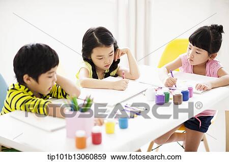 kids at table with sketchbooks and crayons View Large Photo Image Stock Photo - kids at table with sketchbooks and crayons. Fotosearch