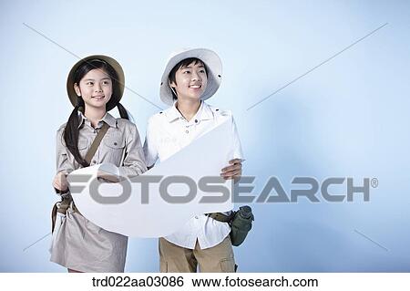 kids dressed as explorers while looking at a map View Large Photo Image Stock Photograph - kids dressed as explorers while looking at a map. Fotosearch