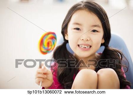 Stock Image - kids eating lollypops. Fotosearch