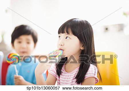 Stock Photo - kids eating lollypops. Fotosearch