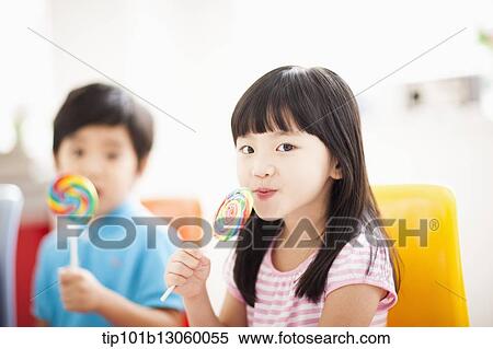 Stock Photography - kids eating lollypops. Fotosearch
