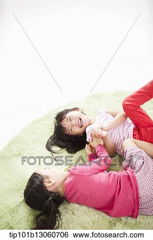 kids lying on a carpet playing View Large Photo Image Stock Photograph - kids lying on a carpet playing. Fotosearch