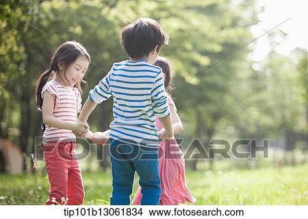 Picture - kids playing in the nature. Fotosearch