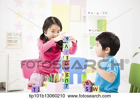 kids playing piling up toy cubes on a table View Large Photo Image Stock Image - kids playing piling up toy cubes on a table. Fotosearch
