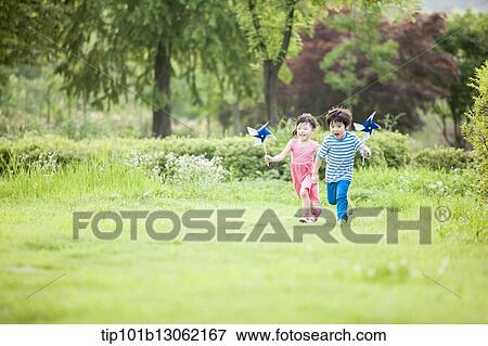 Stock Photo - kids playing with a toy wind mills. Fotosearch