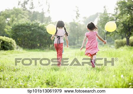 Stock Photo - kids playing with balloons. Fotosearch