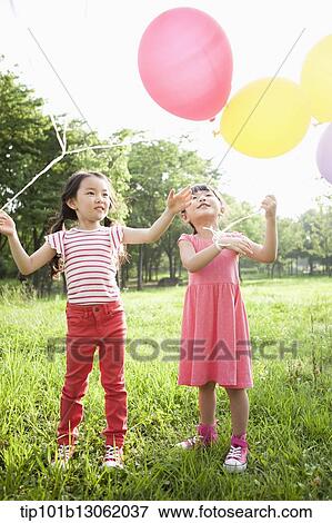 kids playing with balloons View Large Photo Image Stock Photo - kids playing with balloons. Fotosearch