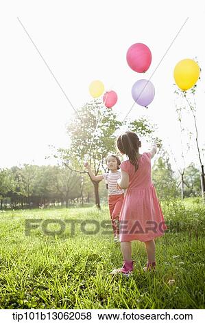 Stock Photo - kids playing with balloons. Fotosearch