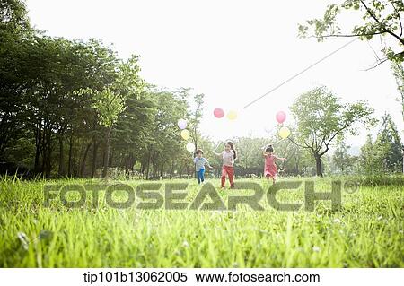Stock Photography - kids playing with balloons. Fotosearch
