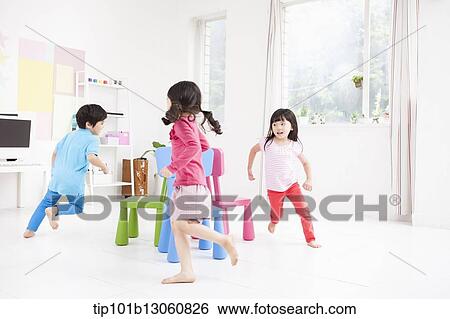 kids playing with different color chairs View Large Photo Image Stock Photograph - kids playing with different color chairs. Fotosearch