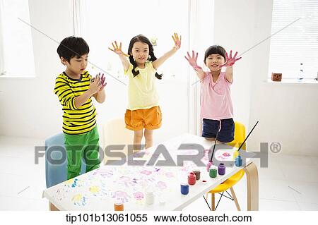 Stock Photography - kids playing with finger colors. Fotosearch
