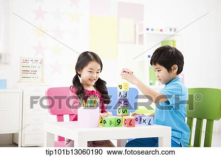kids playing with toy cubes on a table View Large Photo Image Stock Image - kids playing with toy cubes on a table. Fotosearch