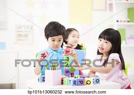 kids playing with toy cubes on a table View Large Photo Image Stock Image - kids playing with toy cubes on a table. Fotosearch
