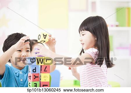 Stock Photography - kids playing with toy cubes on a table. Fotosearch