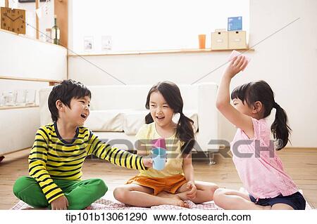 Stock Image - kids playing with toy dishes. Fotosearch